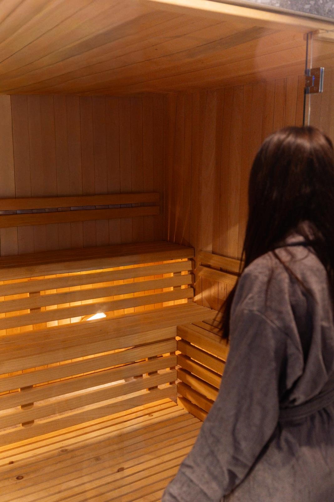 Guest in the Finnish sauna at Cala Lupo Resort